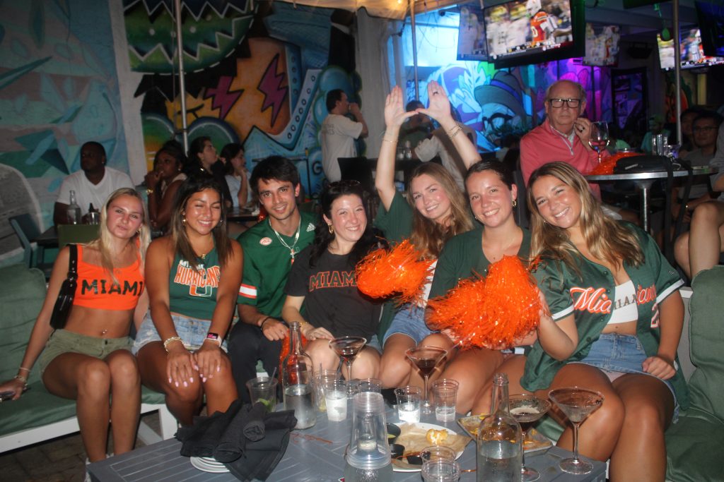 Miami Hurricanes fans cheering during a college football game at Grails Sports Bar Wynwood.