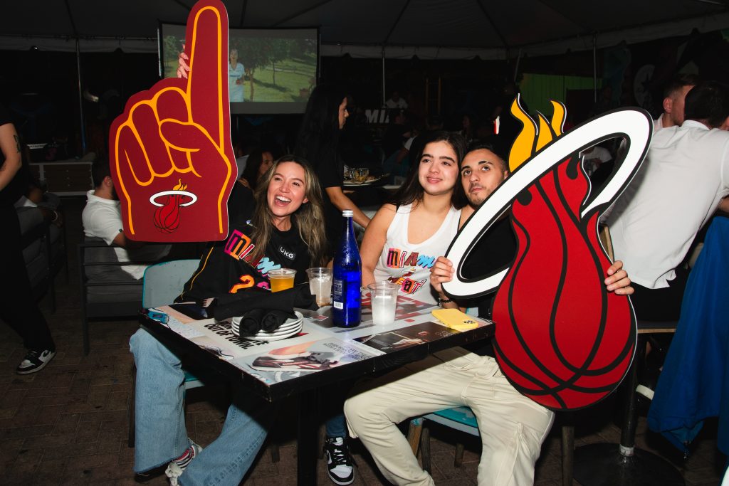 Miami Heat fans cheering during an NBA playoff game at Grails Sports Bar in Wynwood — Miami’s top destination for watching basketball and major sports events.