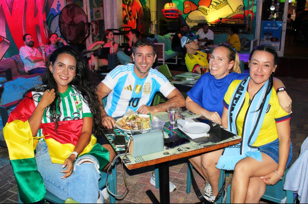 Argentina and soccer fans cheering and waving flags at Grails Sports Bar in Miami during a World Cup match — a top spot for passionate soccer fans to watch every major game.