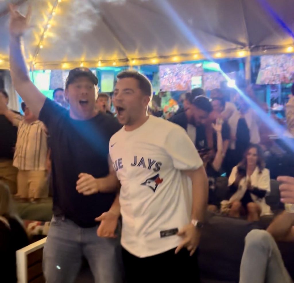 Baseball fans watching the World Series and cheering inside Grails Sports Bar in Wynwood — one of Miami’s best bars to catch every MLB game and championship matchup.