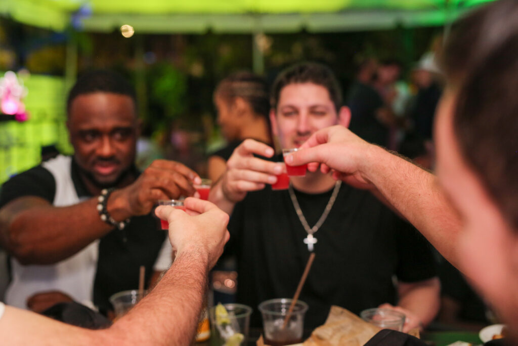 Group of friends having fun during UFC Fight Night in Miami at Grails Sports Bar