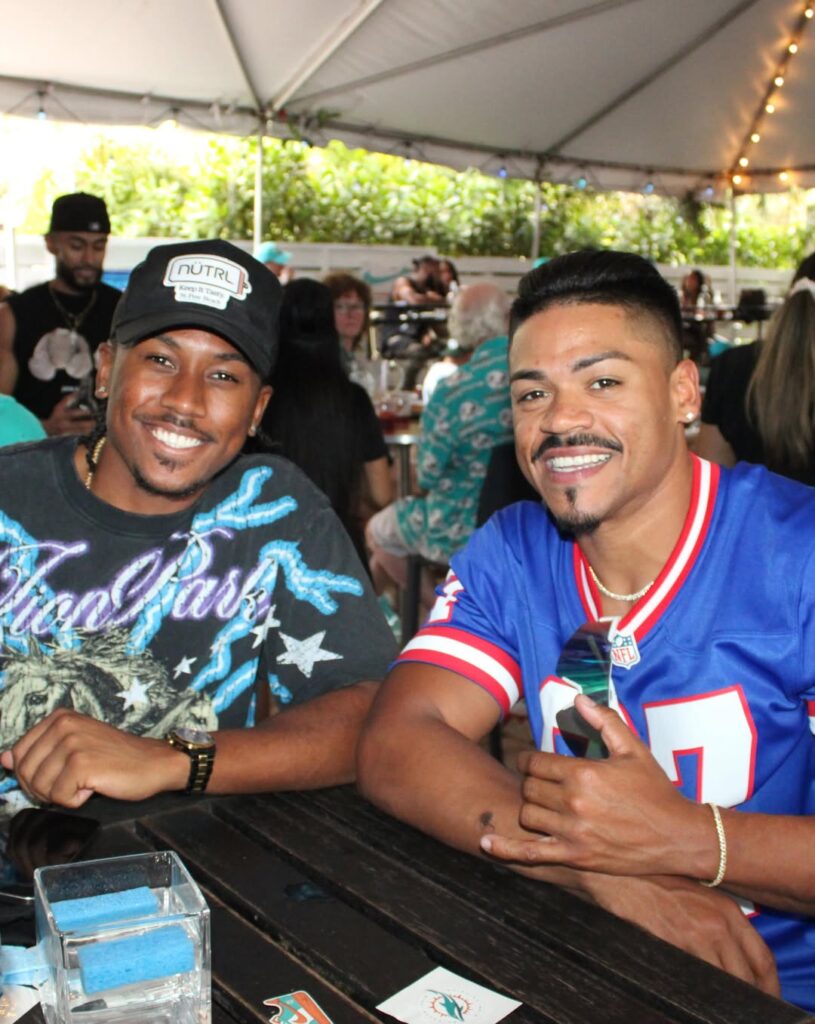 New York Giants fan enjoying NFL Sunday with friends at Grails sports bar in Wynwood, Miami.