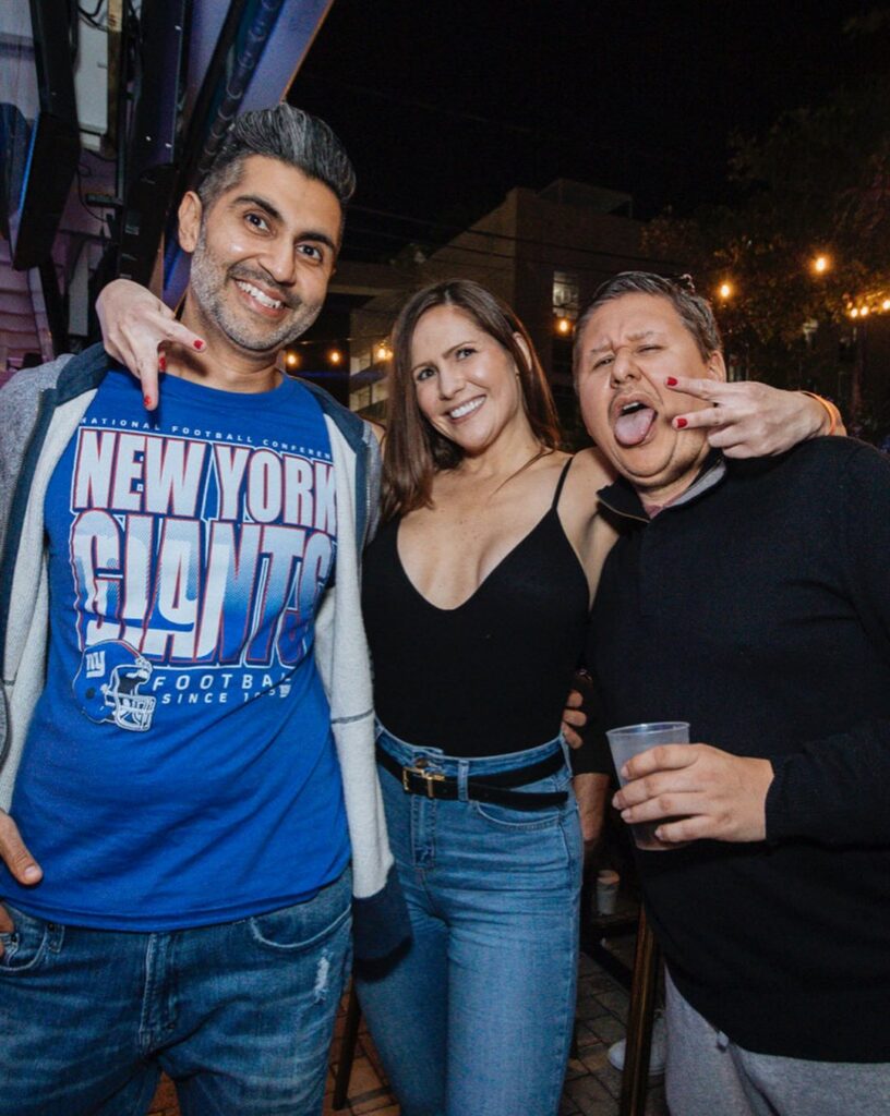 New York Giants fan with friends at Grails Miami in Wynwood during an NFL game day.